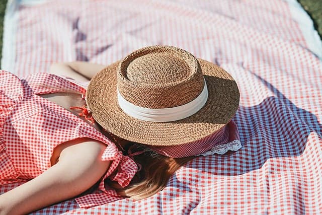 picnic, straw hat, red checkered fabric, summer relaxation, blanket, sleeping person, siesta, summer fashion, summer holiday, outdoor leisure, red color, summer landscape, relaxation, woman, nautical style, rest, beach culture, holiday, countryside